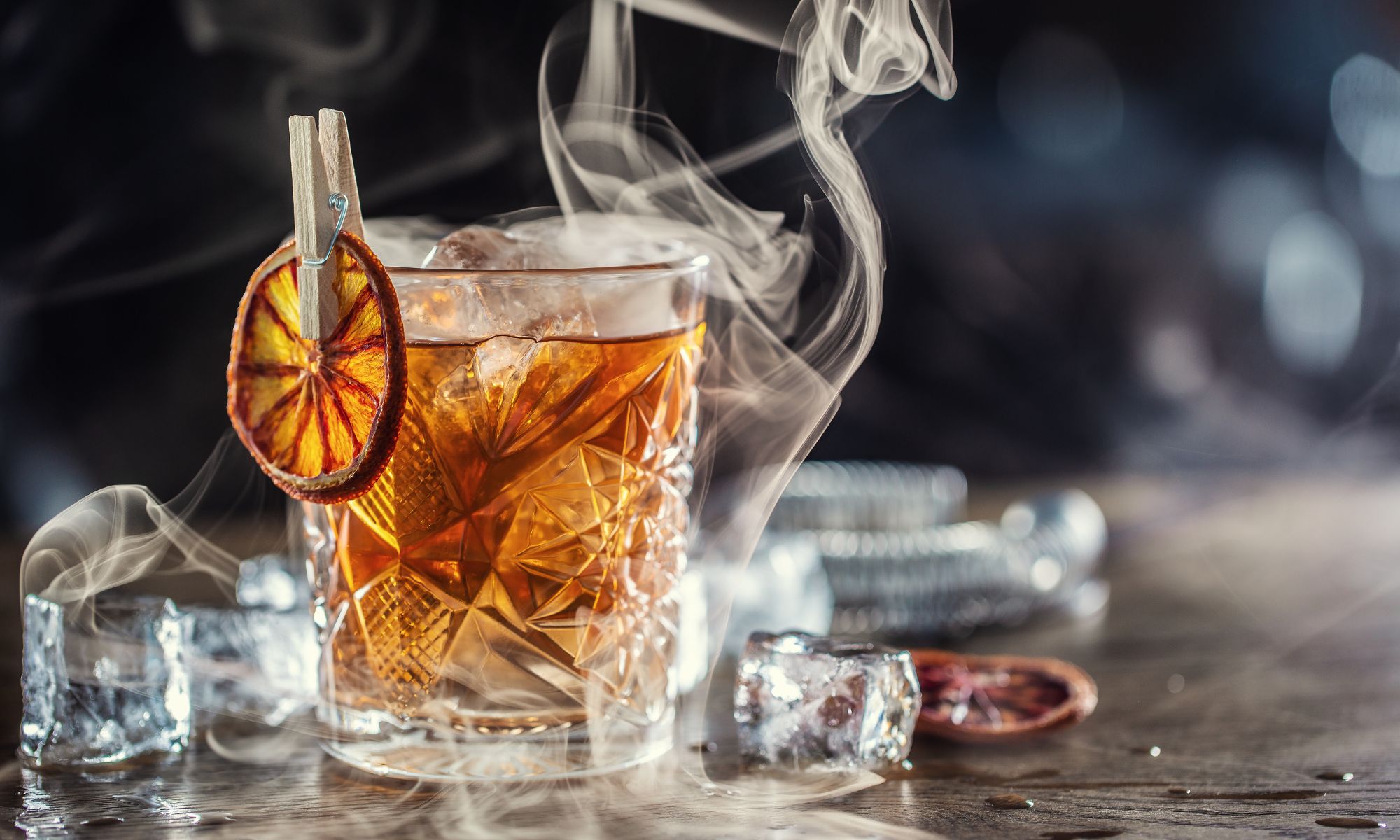 old fashioned cocktail being smoked